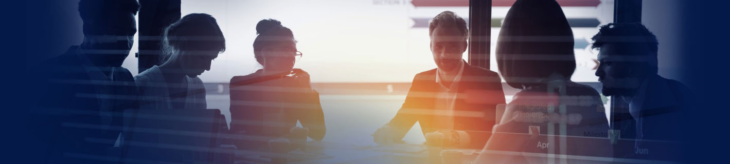 People sitting around a table having a meeting in a sunny, open office