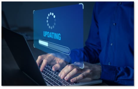 hands on a laptop with a floating 'updating' progress bar screen in front of the screen